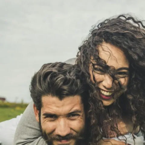 Pareja joven riendo al aire libre